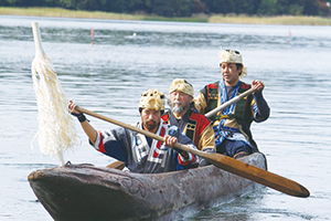 photo of Ainu ethnic costumes and dugout canoe