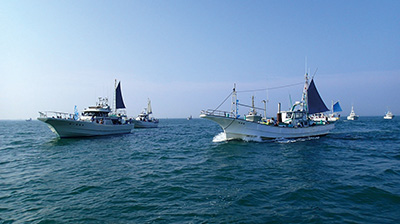 海を進む小型漁船の写真